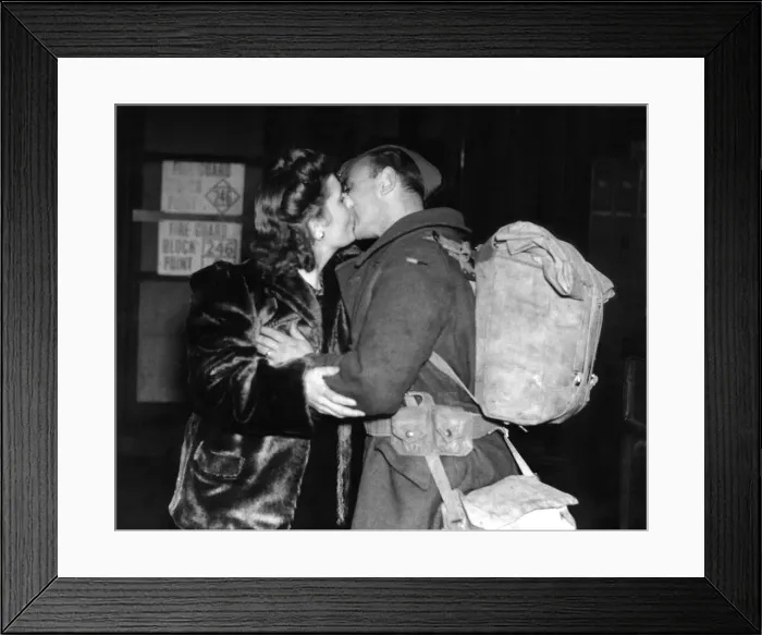 Framed Print : Mrs Wells of Leigh On Sea greets her husband with a kiss at the railway station after Framed Print : Mrs Wells of Leigh On Sea greets her husband with a kiss at the railway station after
