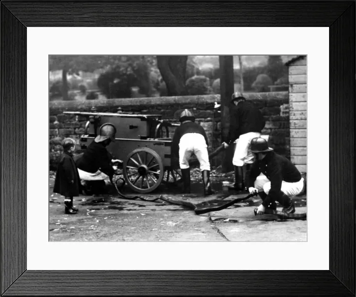 Framed Print : A startled little boy watches firemen in action in Morpeth on October 14, 1950