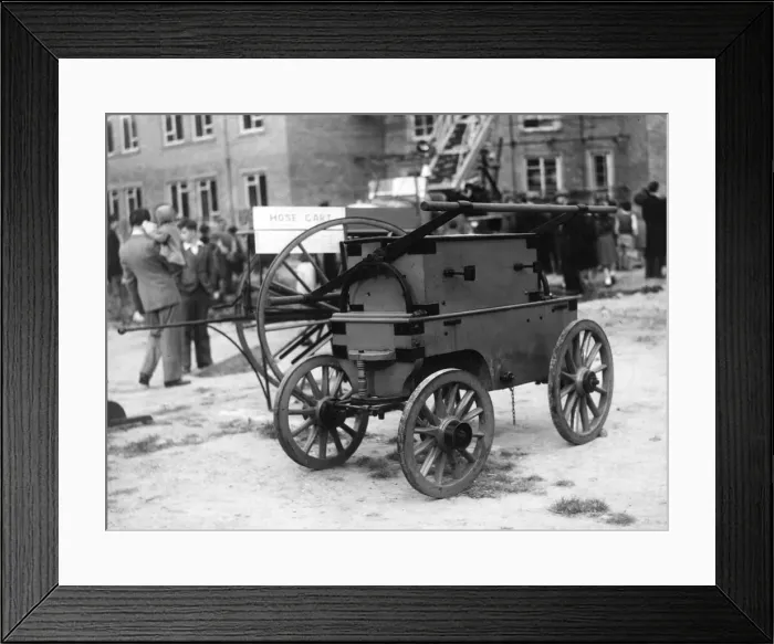 Framed Print : An old firefighters manual water pump in a fire applances demonstation by Durham Fire
