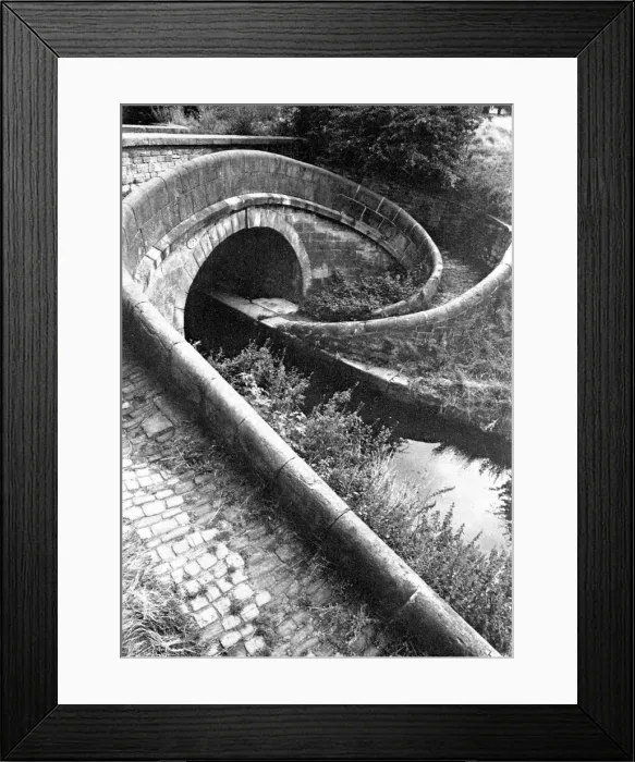 Framed Print : A Turnover bridge, designed to take the towpath from one oside of the canal to the other Framed Print : A Turnover bridge, designed to take the towpath from one oside of the canal to the other