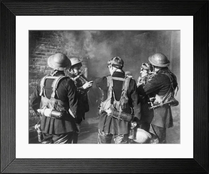 Framed Print : Firefighters check their breathing apparatus and gas masks before moving into a burning Framed Print : Firefighters check their breathing apparatus and gas masks before moving into a burning