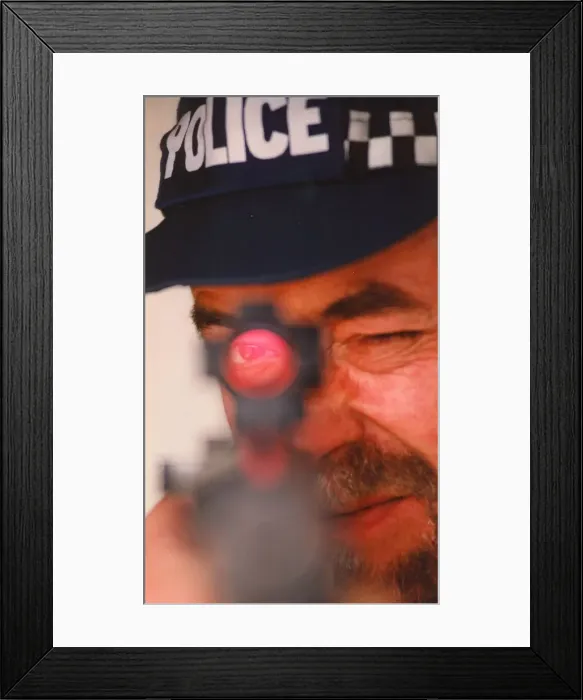 Framed Print : A police marksman aims his gun