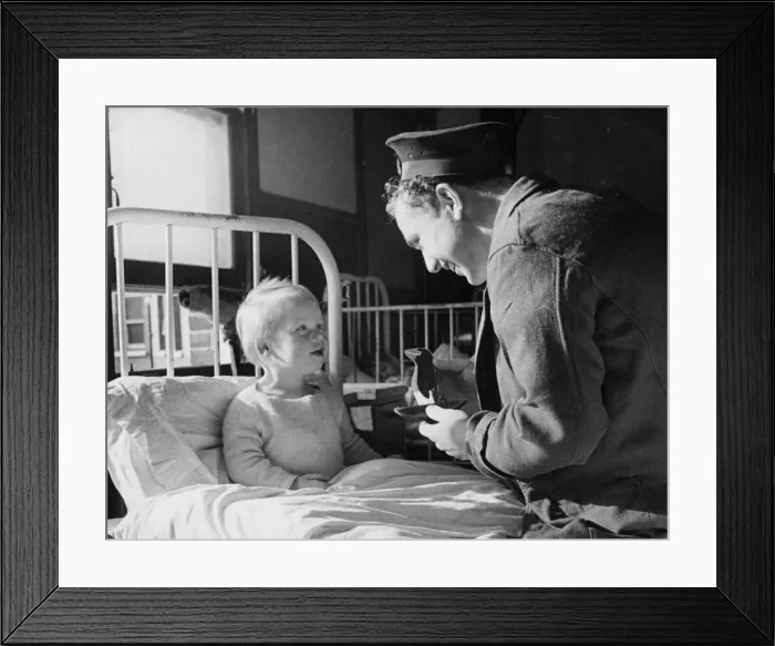 Framed Print : Sailor Gordon Davis of the Royal Navy repais the doll of a patient in the childrens ward Framed Print : Sailor Gordon Davis of the Royal Navy repais the doll of a patient in the childrens ward