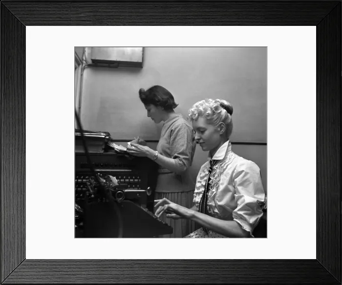 Framed Print : General office scene: Secretary taking notes and answering the phone in a Birmingham Framed Print : General office scene: Secretary taking notes and answering the phone in a Birmingham