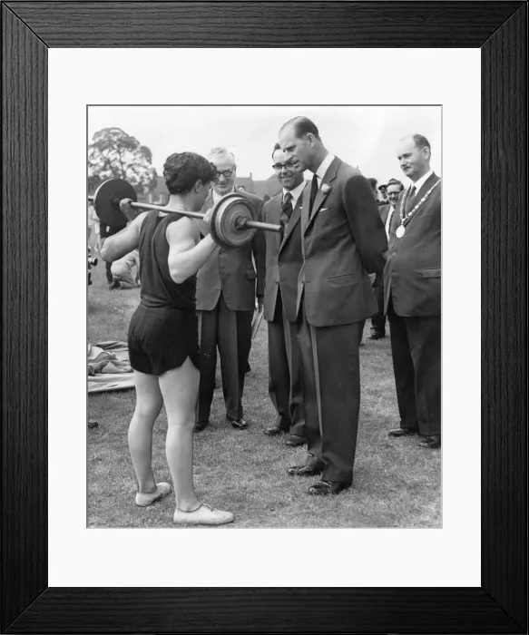 Framed Print : Prince Philip, Duke of Edinburgh, shows interest in a demonstation of weight-lifting