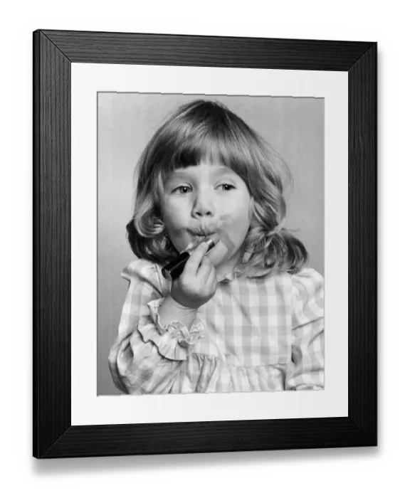 Framed Print : Emma Varsanyi. March 1976 P034769 Little girl putting on lipstick