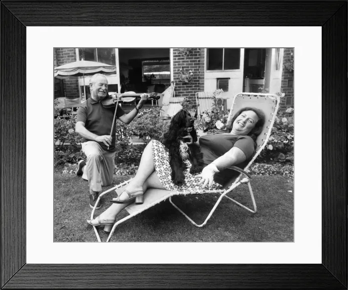 Framed Print : Janet relaxes at home with her husband Charles, a professional violinist