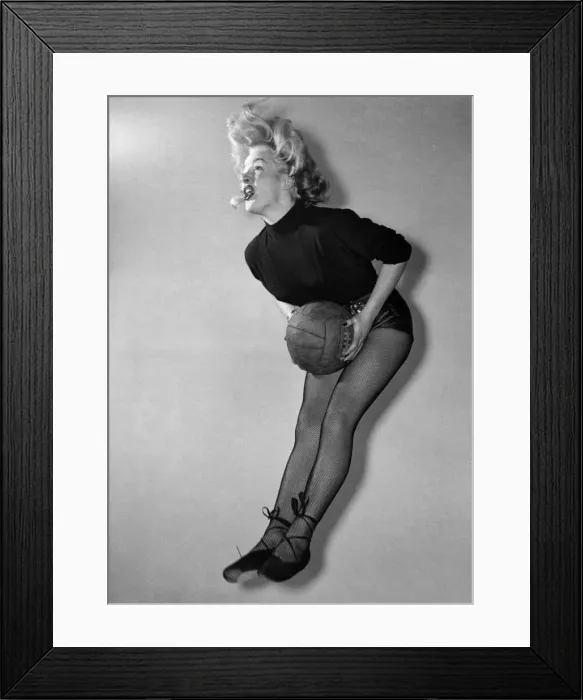 Framed Print : At Pinewood, the stage hands play the girls at netball, between shots on the film