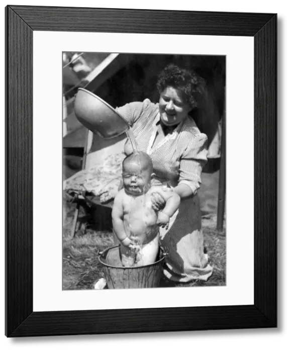 Framed Print : Children: Washing: Mrs. Ann Farrier gives her son 8 months old John his morning bath in a