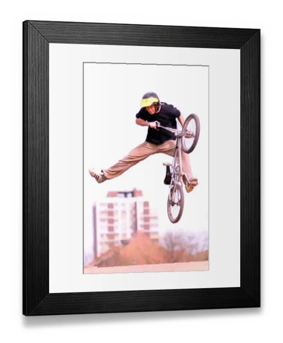 Framed Print : A man performing stunts on his BMX bike