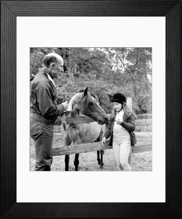 Framed Print : Sterling Moss (Ex Racing Driver). Seen here with horse and daughter Framed Print : Sterling Moss (Ex Racing Driver). Seen here with horse and daughter