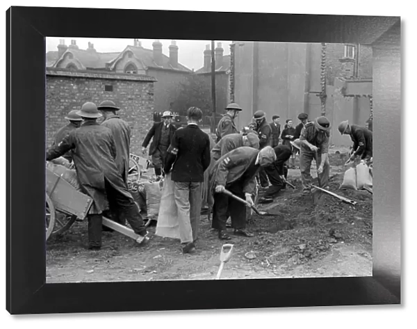 Alfieri. Fire Guards and ARP Wardens digging trenches for sand bag defences during