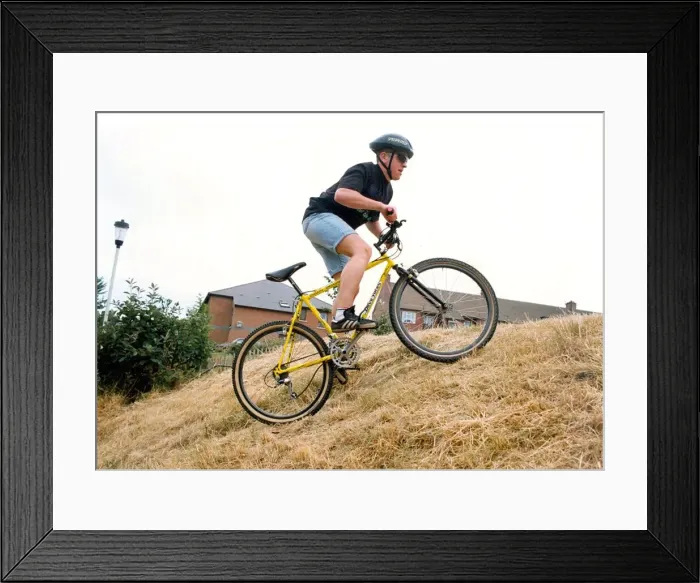 Framed Print : A man on his Diablo mountain bike climbing hills Framed Print : A man on his Diablo mountain bike climbing hills