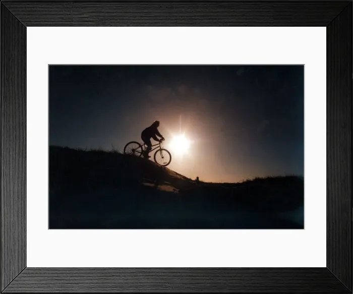 Framed Print : A man riding his mountain bike cross country