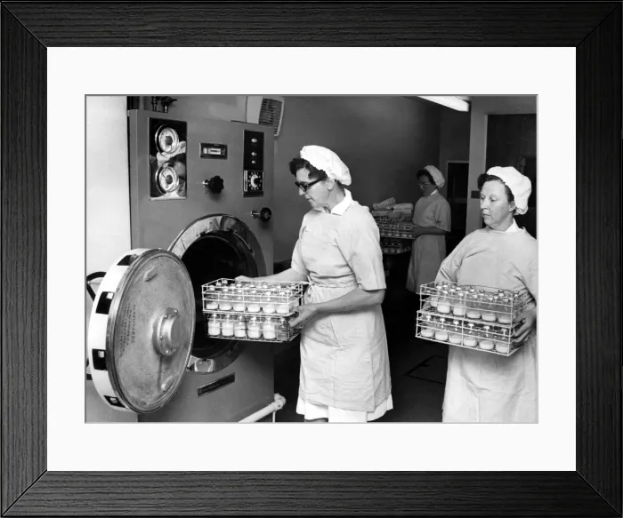 Framed Print : Babies milk bottles being taken out of the sterilising machine at the maternity unit Framed Print : Babies milk bottles being taken out of the sterilising machine at the maternity unit