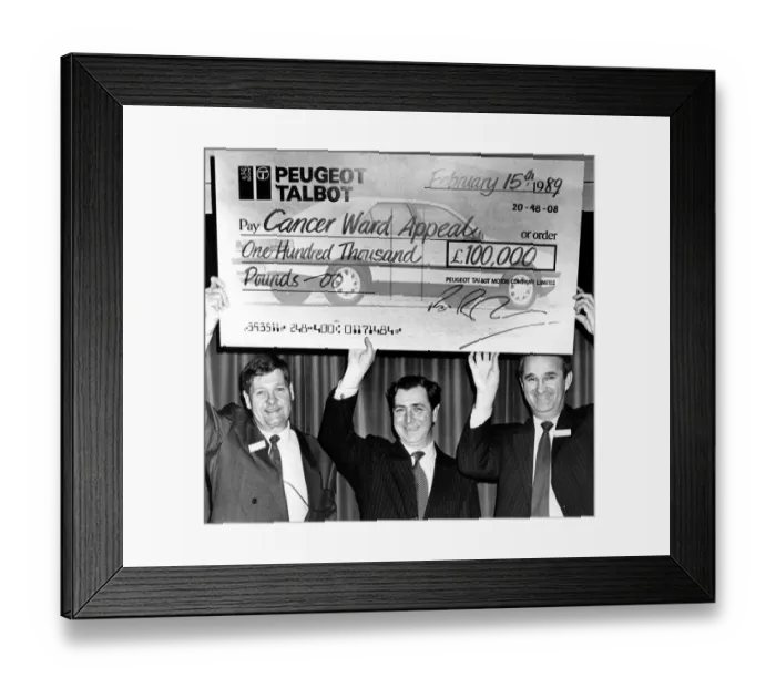 Framed Print : Richard Parham(right), assistant MD at Peugeot get help with the oversized cheque