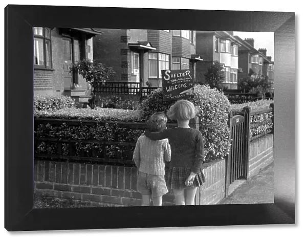 Young girl and boy reading an air raid shelter sign