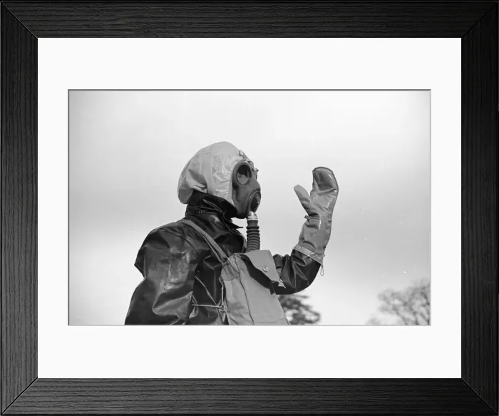 Framed Print : Preparations for war. ARP warden gets use to his gas mask Framed Print : Preparations for war. ARP warden gets use to his gas mask