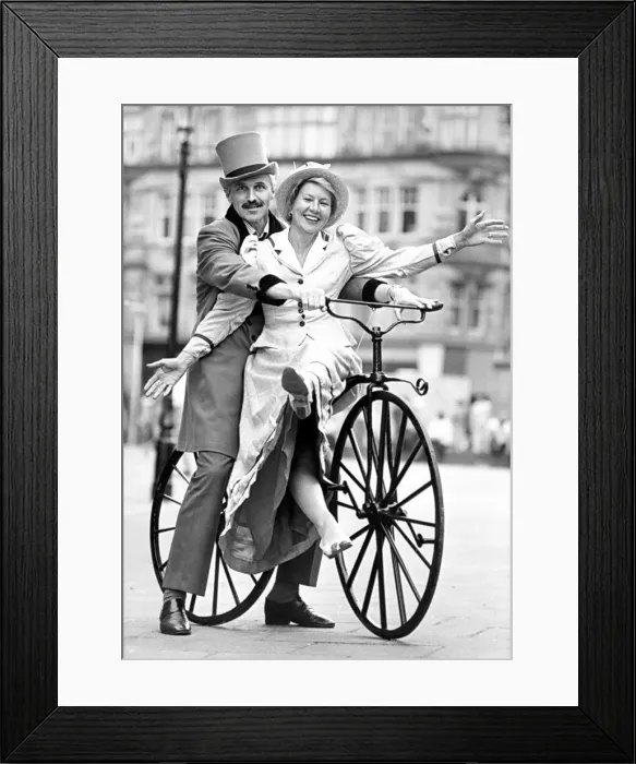 Framed Print : Hazel Hesse and John silkstone try out a vintage bicycle at the launch of their charity Framed Print : Hazel Hesse and John silkstone try out a vintage bicycle at the launch of their charity