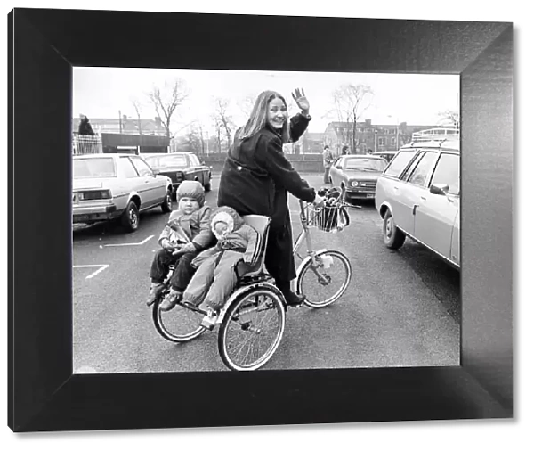 Young mum Vivien Simpson transports her two toddlers around on a chair fitted to the back