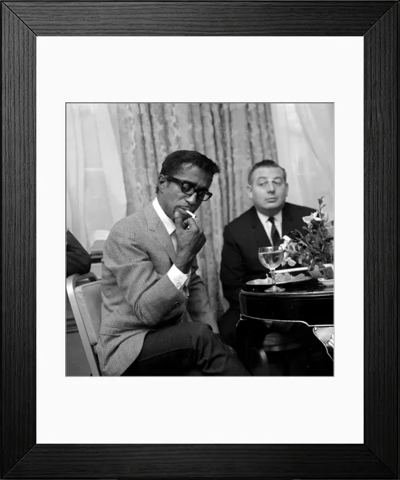 Framed Print : Sammy Davis Jnr. lights a cigarette in a London restaurant whilst having lunch with Framed Print : Sammy Davis Jnr. lights a cigarette in a London restaurant whilst having lunch with
