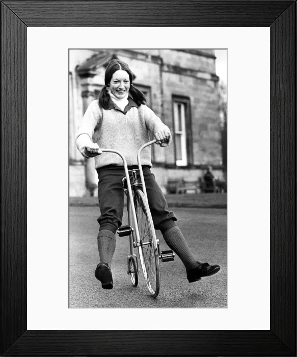 Framed Print : Pat McDonald tries out a scalle model of a Penny Farthing Framed Print : Pat McDonald tries out a scalle model of a Penny Farthing