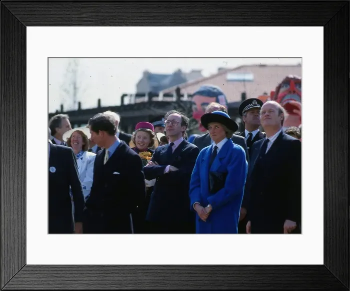 Framed Print : Princess Diana, Princess of Wales, wearing a blue coat, watching the Coca Cola ride with Framed Print : Princess Diana, Princess of Wales, wearing a blue coat, watching the Coca Cola ride with