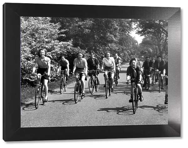 Cyclists out for a spin along a country lane near Belsay in Northumberland in 1950
