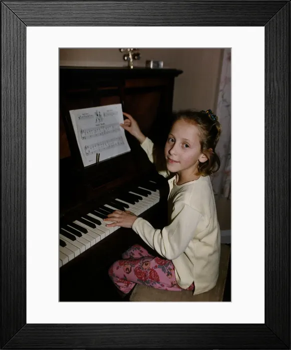 Framed Print : Ruth Walton one of the Walton Sextuplets sits at a piano to play dbase