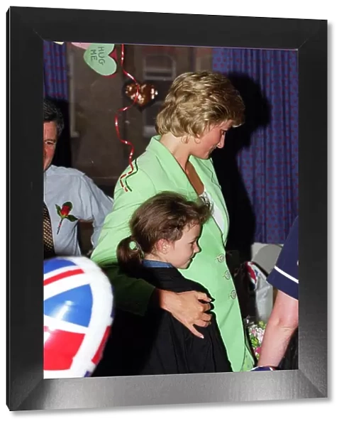 Diana, Princess of Wales with her arm round Danielle Stephenson on a visit to a