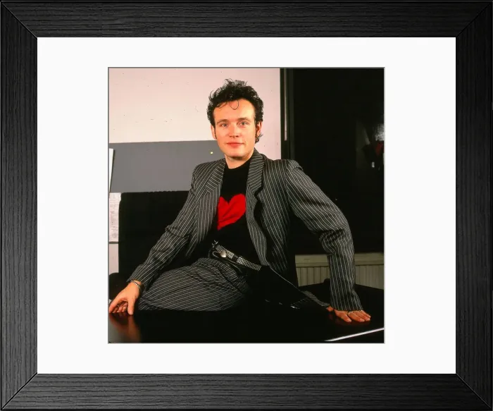 Framed Print : Adam Ant pop singer sitting on desk January 1990 Striped suit black jumper red Framed Print : Adam Ant pop singer sitting on desk January 1990 Striped suit black jumper red