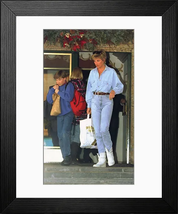 Framed Print : Diana, Princess of Wales carries a bag for her son Prince William as he leaves