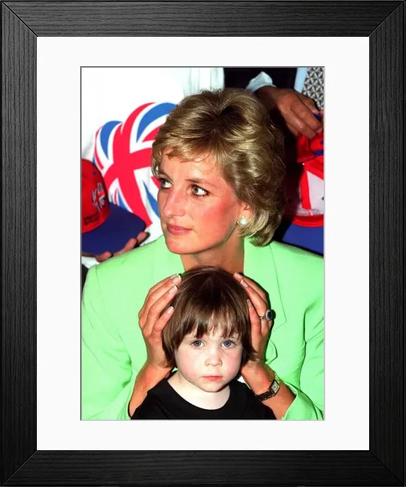Framed Print : Princess Diana sitting with Caitlin Hines on her lap during a visit to a children