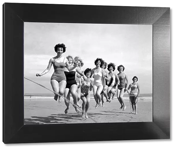 Beauty contest girls playing on the beach at Newquay. 7th July 1960