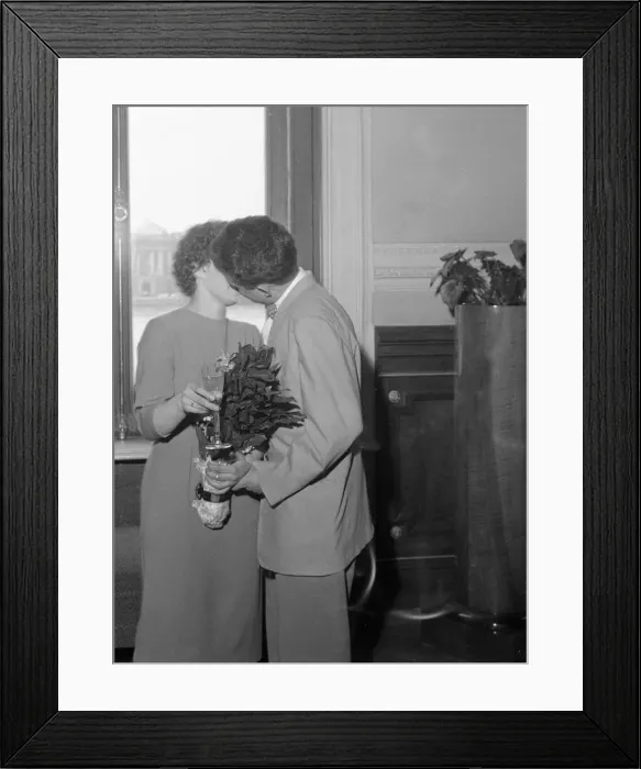 Framed Print : A newly married Russian couple kissing in the registrar office in Leningrad