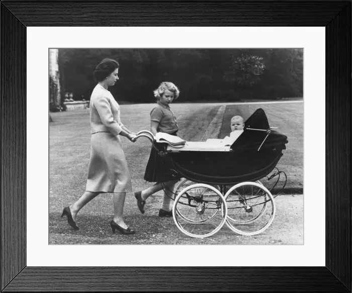 Framed Print : Queen Elizabeth II and Princess Anne take baby Prince Andrew for a ride in his high pram Framed Print : Queen Elizabeth II and Princess Anne take baby Prince Andrew for a ride in his high pram