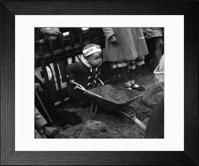 Framed Print : Toddler building a sandcastle at Blackpool beach August 1958