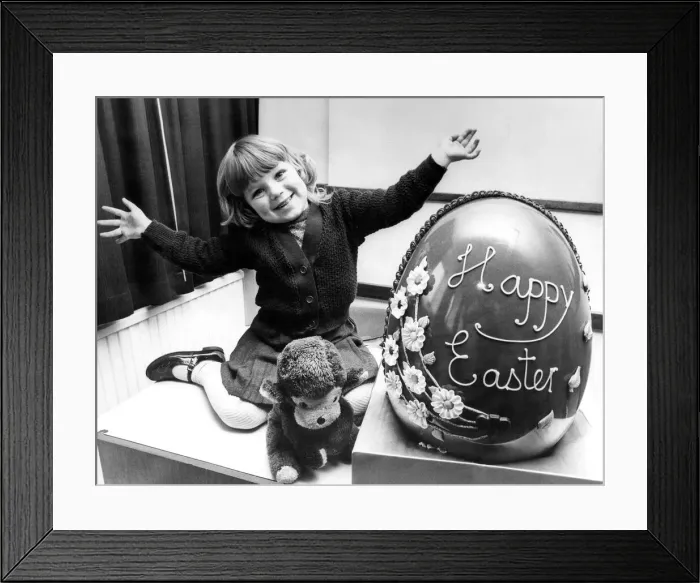 Framed Print : Sizing up the giant Easter egg is three year old Janette Lee, of Cheviot Court, Wallsend