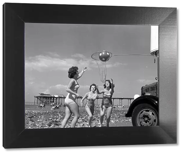 Beauty contest girls playing netball at Hunstanton, UK. 25th August 1959