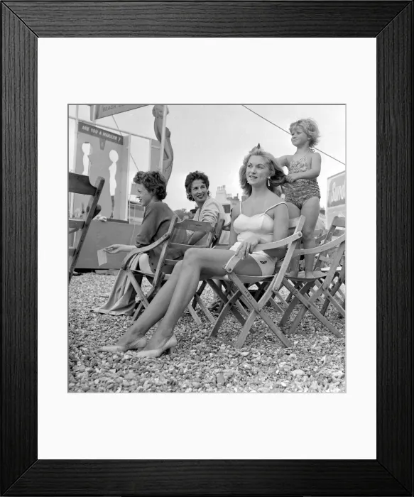 Framed Print : Marilyn Monroe look-a-like competition at Hastings. Child combing mothers hair