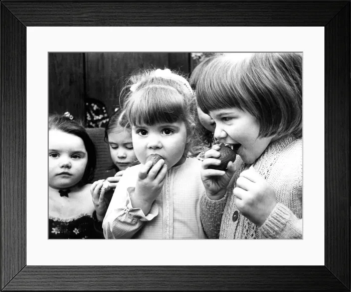 Framed Print : Some schoolchildren eating mini Easter eggs in 1975 Framed Print : Some schoolchildren eating mini Easter eggs in 1975