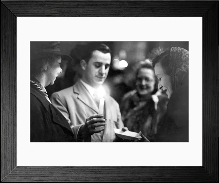 Framed Print : A stallholder desplays his wares by the light of a candle in Newcastles Grainger Market