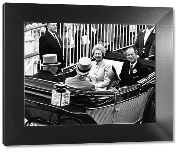 Queen Elizabeth II and Prince Philip drive down the course at Royal Ascot