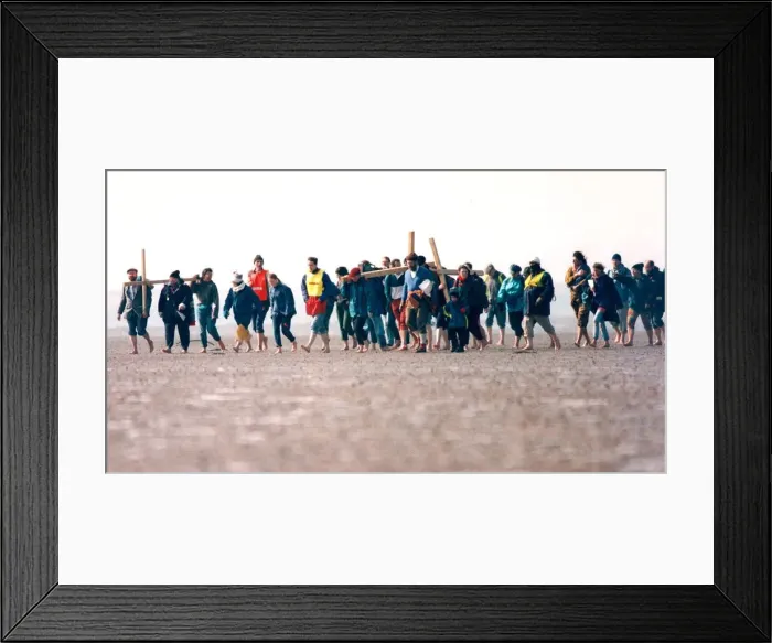 Framed Print : A group of pilgrims crossing the causeway at Holy Island on their way to St Framed Print : A group of pilgrims crossing the causeway at Holy Island on their way to St