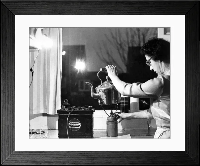 Framed Print : In the kitchen a spare car battery and a headlamp bulb give enough light to work in Framed Print : In the kitchen a spare car battery and a headlamp bulb give enough light to work in