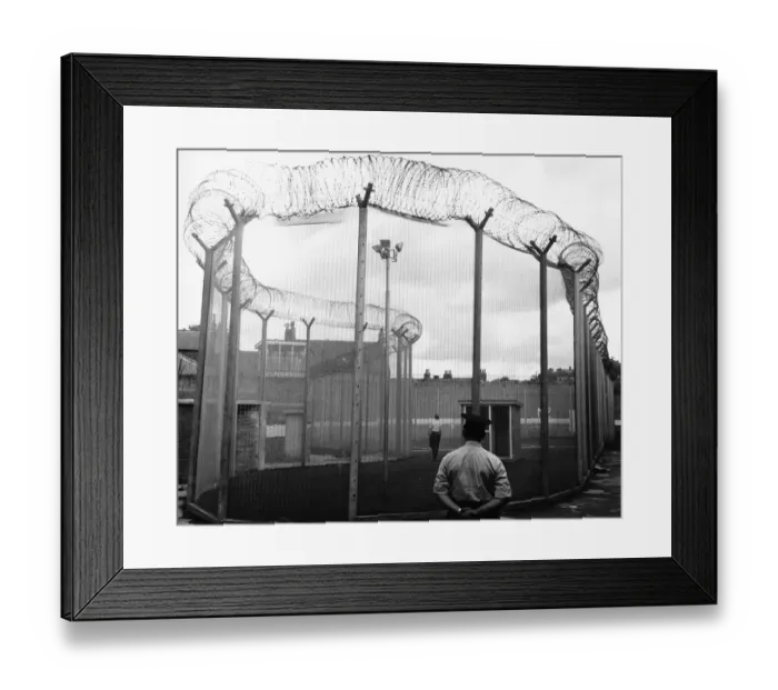 Framed Print : Durham Prison security wing a man in the exercise cage at Durham jail watched by a warder