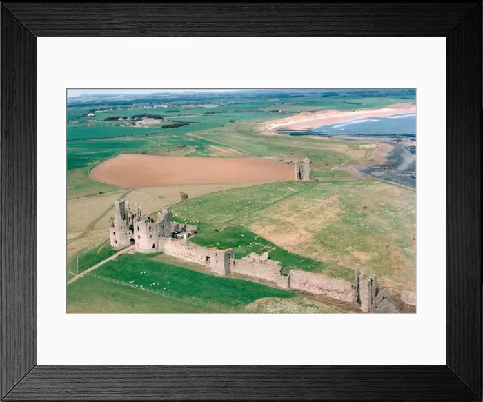 Framed Print : The remote and impressive ruins of Northumberlands Dunstanburgh Castle in July 1999