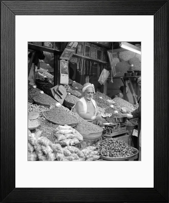 Framed Print : Trader in vegetables and spices sits outside his shop in Peshawar the capital of Framed Print : Trader in vegetables and spices sits outside his shop in Peshawar the capital of
