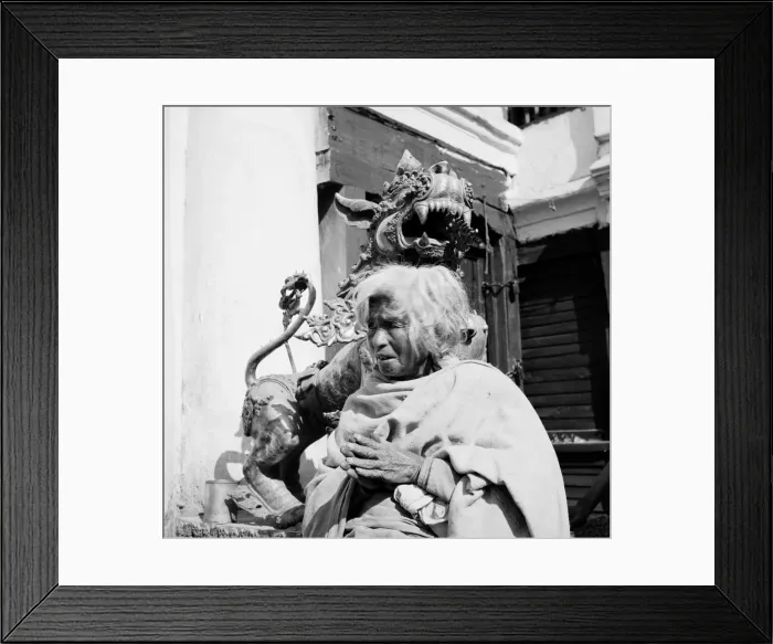 Framed Print : Nepalese woman poses beside a sculpture of a Dragon dog guarding a shrine in Katmandu Framed Print : Nepalese woman poses beside a sculpture of a Dragon dog guarding a shrine in Katmandu