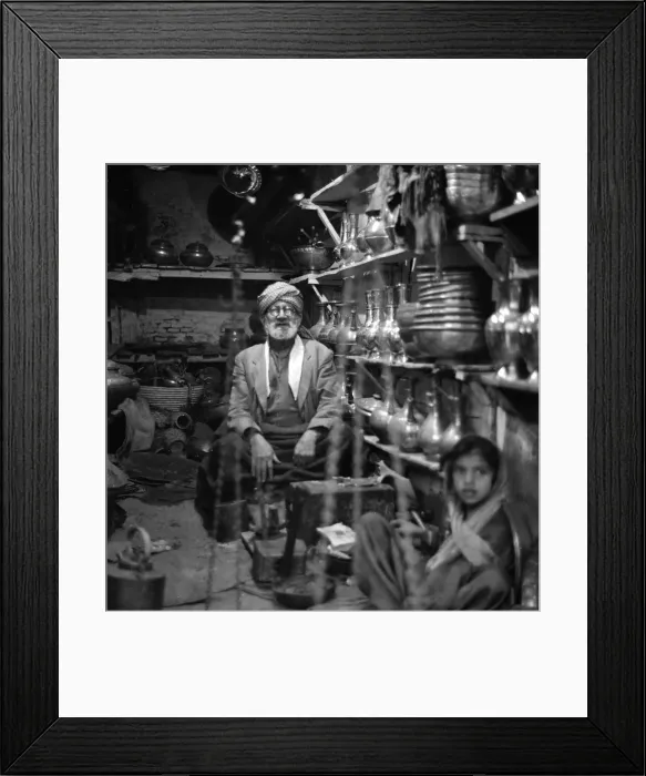 Framed Print : Traders sit inside their shop in Peshawar amongst the pots and pans Framed Print : Traders sit inside their shop in Peshawar amongst the pots and pans